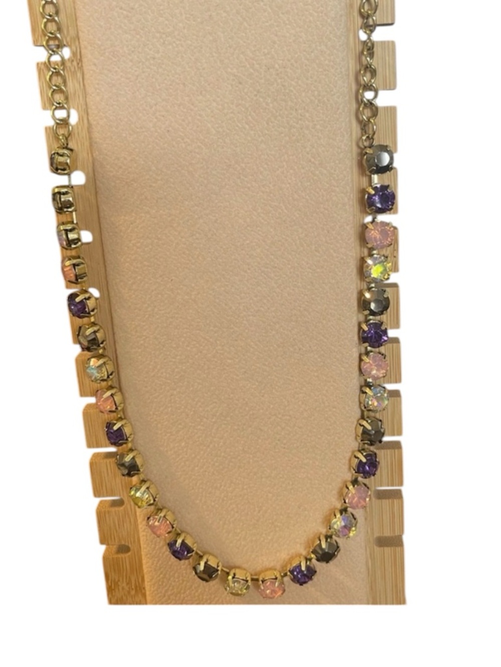Necklace with purple, pink, clear, tan stones.